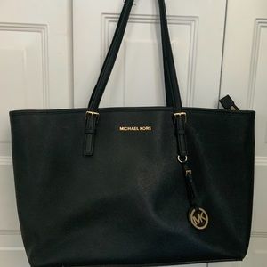 Large Michael Kors Tote bag w/ laptop pocket enclosure.